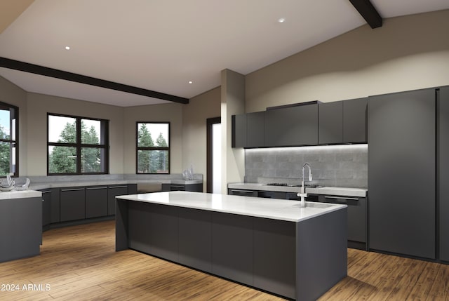 kitchen with modern cabinets, light countertops, vaulted ceiling with beams, decorative backsplash, and gray cabinetry