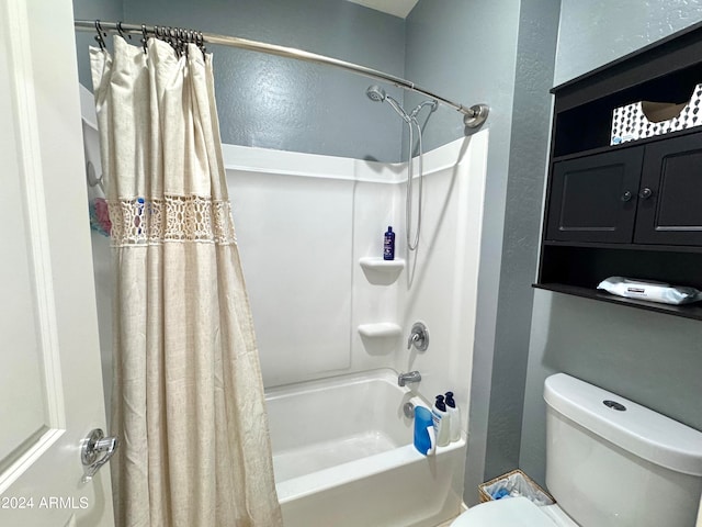 bathroom featuring shower / tub combo with curtain and toilet