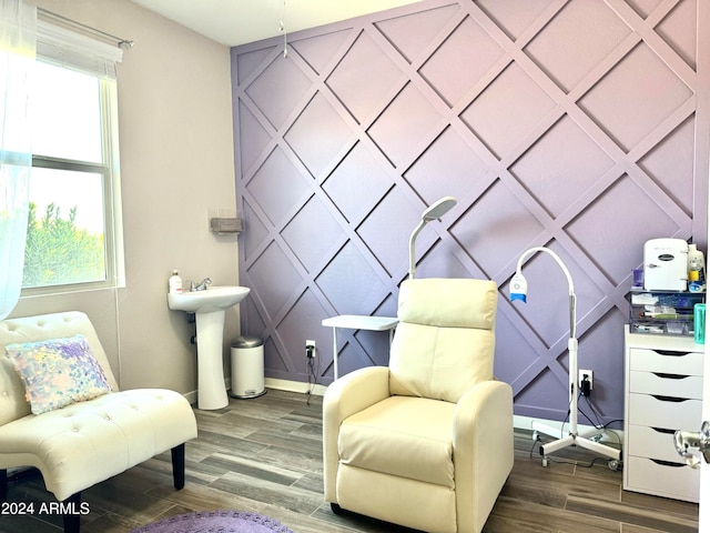 living area featuring hardwood / wood-style flooring and sink