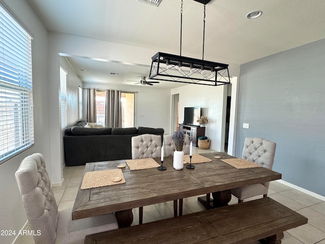 tiled dining area featuring ceiling fan and plenty of natural light