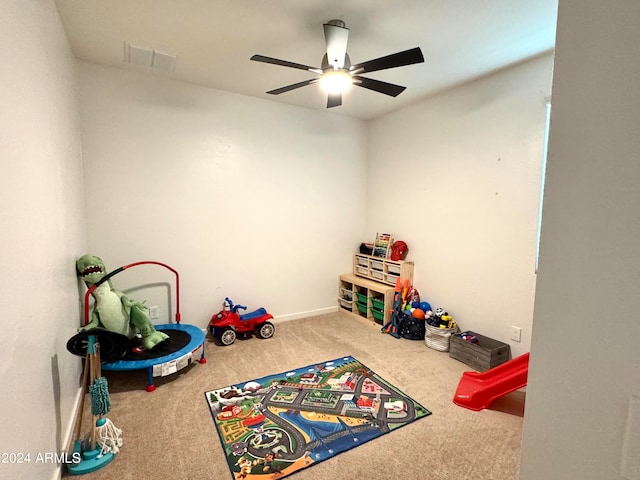 recreation room with carpet floors and ceiling fan