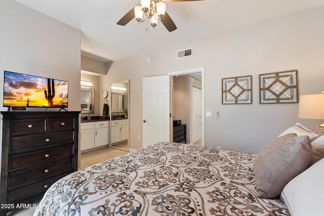 bedroom featuring a ceiling fan, visible vents, and connected bathroom