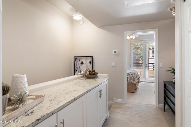 bar featuring baseboards and light colored carpet