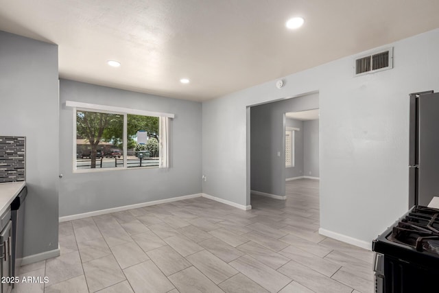2936 E Beck Ln, Phoenix, AZ 85032 - interior space featuring light countertops, freestanding refrigerator, recessed lighting, gas range, and visible vents
