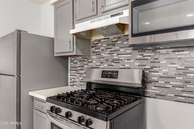 2936 E Beck Ln, Phoenix, AZ 85032 - kitchen featuring under cabinet range hood, light countertops, appliances with stainless steel finishes, and tasteful backsplash