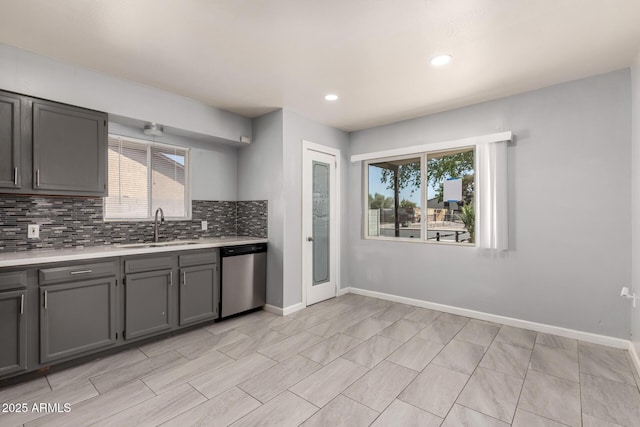 2936 E Beck Ln, Phoenix, AZ 85032 - kitchen with stainless steel dishwasher, a sink, light countertops, gray cabinetry, and a wealth of natural light