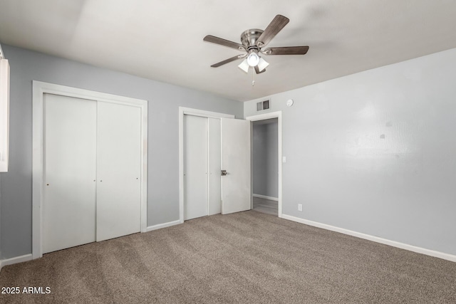 2936 E Beck Ln, Phoenix, AZ 85032 - unfurnished bedroom with visible vents, a ceiling fan, multiple closets, baseboards, and carpet flooring
