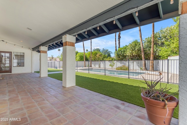 view of patio with fence and a fenced in pool