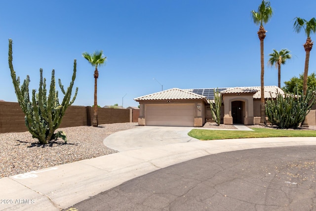 16288 W Hadley St, Goodyear, AZ 85338 - view of front facade with a tiled roof, a garage, stucco siding, driveway, and solar panels