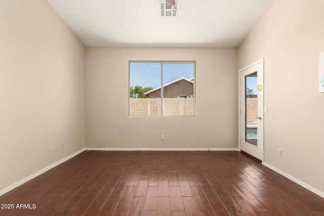 16288 W Hadley St, Goodyear, AZ 85338 - spare room featuring plenty of natural light and dark wood-style floors