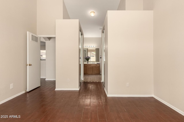 16288 W Hadley St, Goodyear, AZ 85338 - empty room with dark wood-style flooring and baseboards