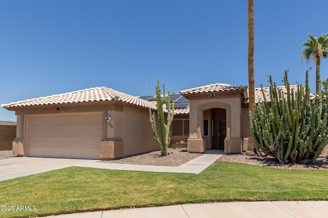 16288 W Hadley St, Goodyear, AZ 85338 - mediterranean / spanish-style house with an attached garage, roof mounted solar panels, stucco siding, concrete driveway, and a front yard