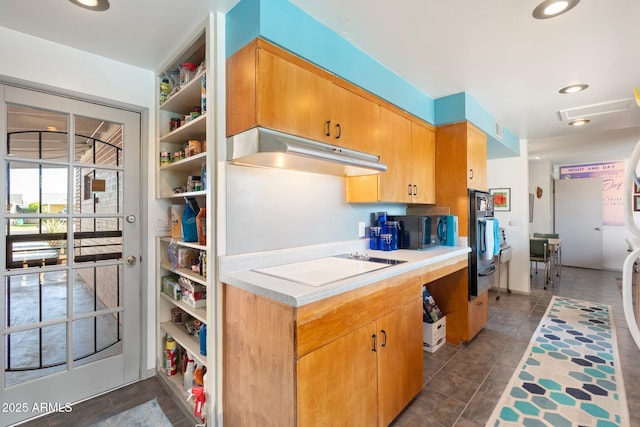 kitchen with under cabinet range hood, white electric stovetop, recessed lighting, and light countertops