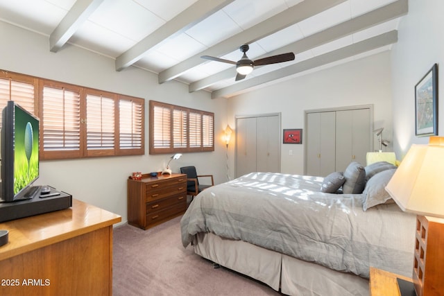 carpeted bedroom featuring vaulted ceiling with beams, multiple closets, and ceiling fan