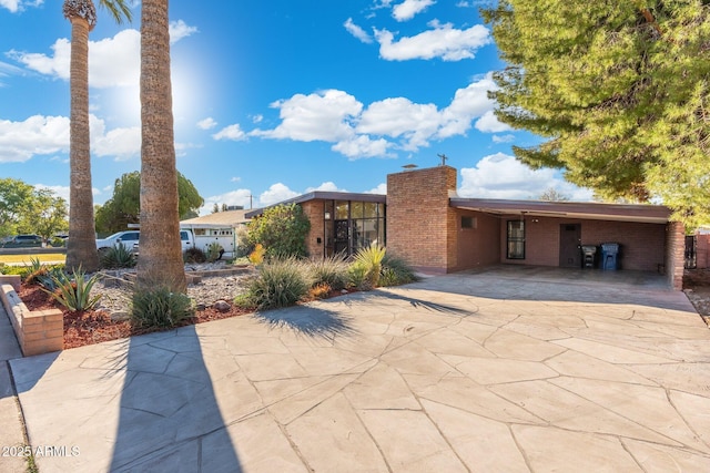 view of patio with a carport and driveway