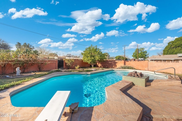 view of swimming pool with a fenced in pool, a patio, a fenced backyard, and a diving board