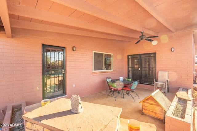 view of patio featuring outdoor dining area and a ceiling fan