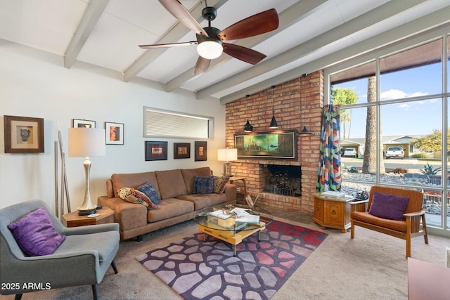 carpeted living area with a brick fireplace, vaulted ceiling with beams, and ceiling fan