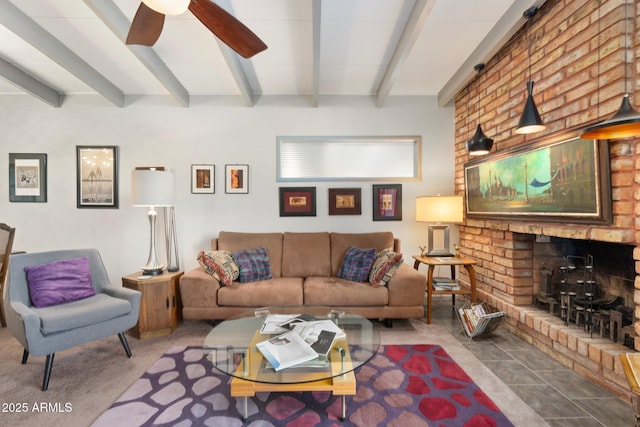 living area featuring beamed ceiling, a brick fireplace, and ceiling fan