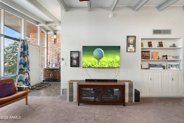 carpeted living area featuring beam ceiling and visible vents