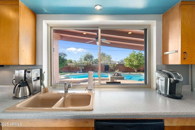 kitchen featuring a sink, dishwasher, and light countertops