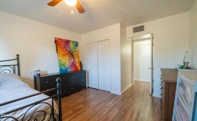 bedroom featuring ceiling fan, a closet, and wood-type flooring