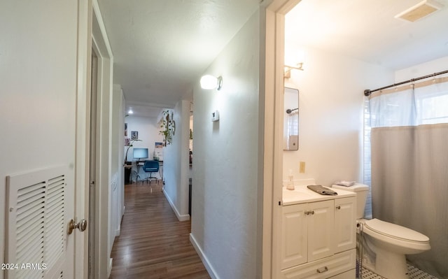 corridor featuring dark hardwood / wood-style floors