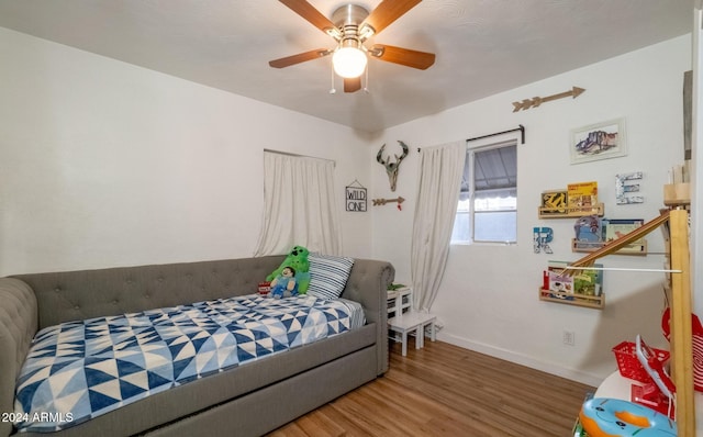 bedroom featuring wood-type flooring and ceiling fan