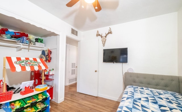 bedroom with ceiling fan and hardwood / wood-style flooring