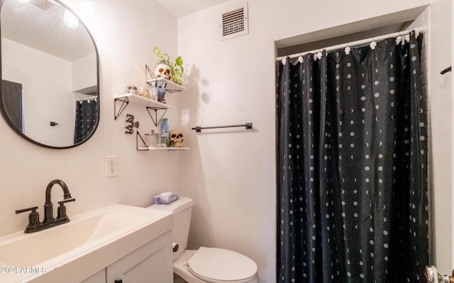 bathroom featuring a shower with curtain, vanity, and toilet