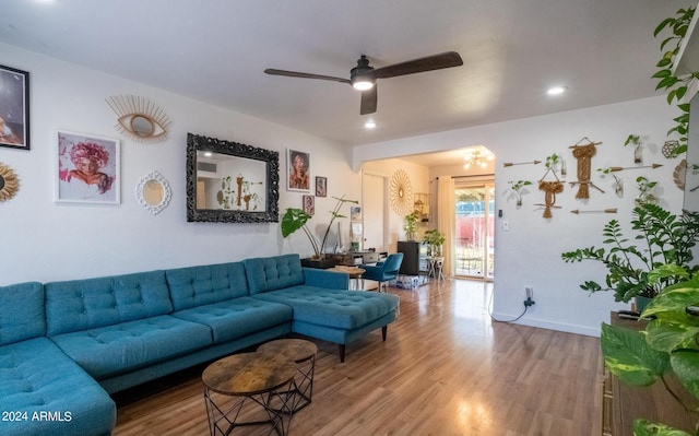 living room with wood-type flooring and ceiling fan