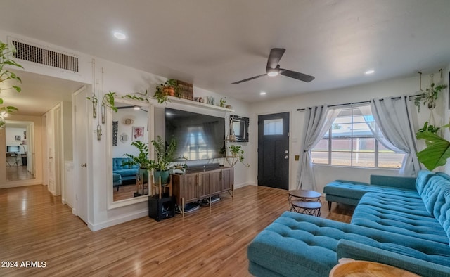 living room featuring ceiling fan and light hardwood / wood-style flooring