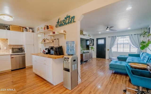 kitchen with dishwasher, light hardwood / wood-style floors, white cabinets, ceiling fan, and butcher block countertops