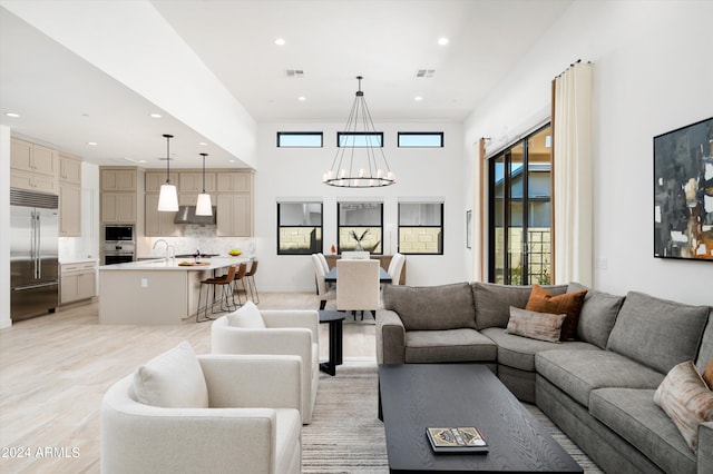 living room with an inviting chandelier and sink