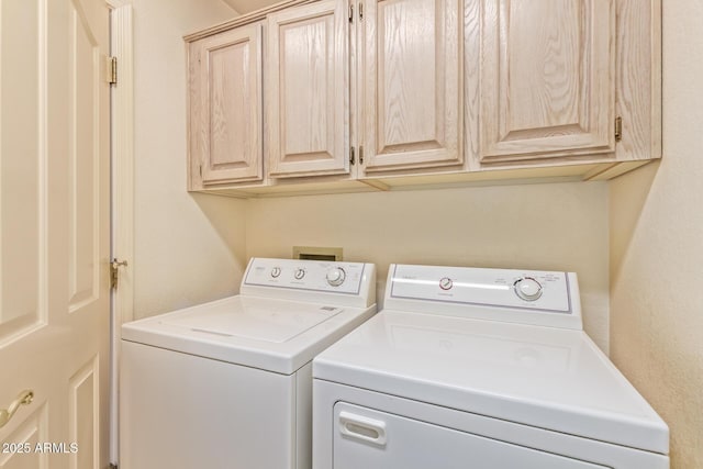 laundry room with cabinet space and washer and clothes dryer