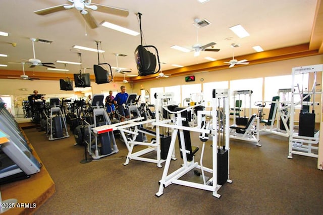 gym featuring visible vents and a ceiling fan