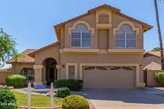 mediterranean / spanish house with a garage