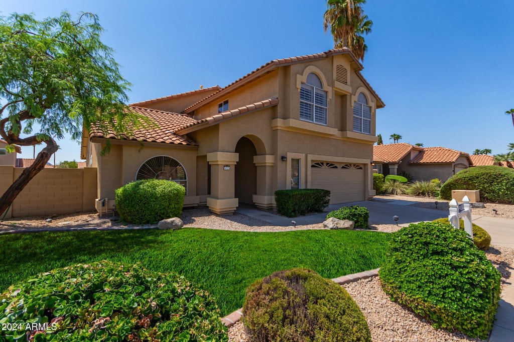 mediterranean / spanish house with a garage