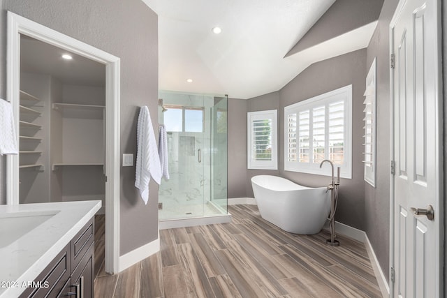 bathroom with vanity, a healthy amount of sunlight, hardwood / wood-style flooring, and separate shower and tub