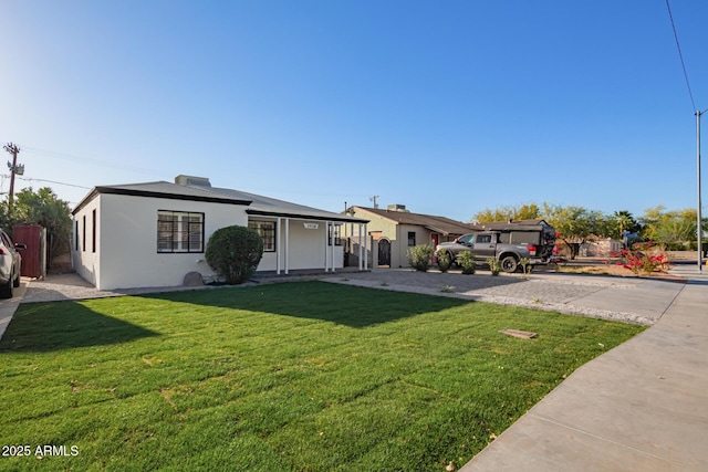 ranch-style house with a front lawn and stucco siding