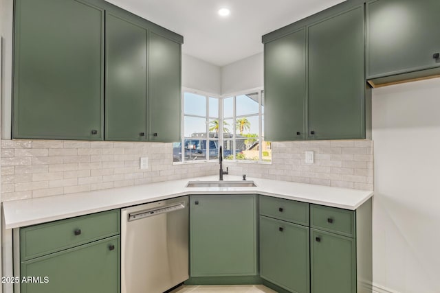 kitchen with a sink, light countertops, decorative backsplash, stainless steel dishwasher, and green cabinetry