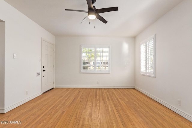 unfurnished room with light wood-type flooring, baseboards, and a ceiling fan