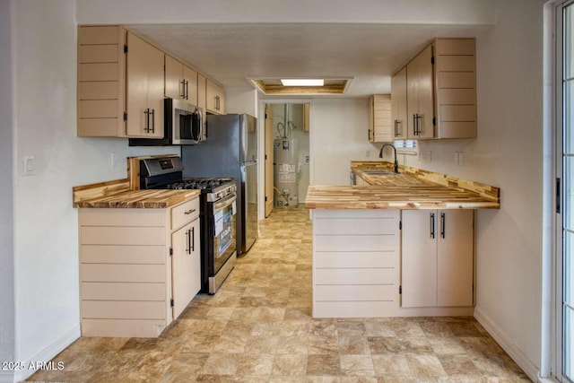 813 N Glenrosa Blvd, Taylor, AZ 85939 - kitchen featuring stainless steel appliances, a sink, a peninsula, water heater, and baseboards