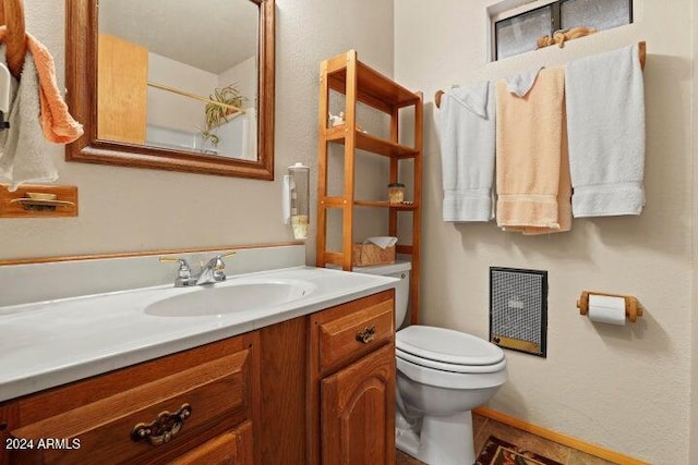 bathroom with vanity and toilet