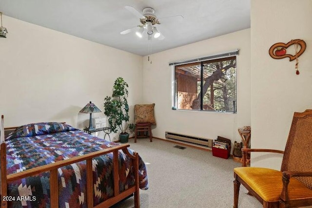 bedroom with carpet, ceiling fan, and a baseboard heating unit