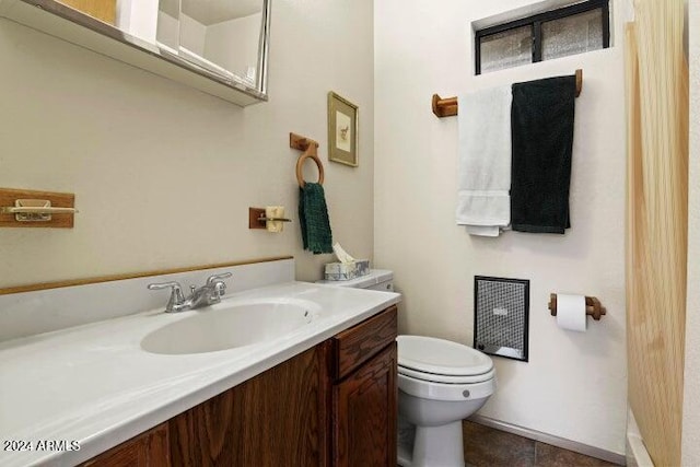 bathroom with tile patterned floors, vanity, and toilet