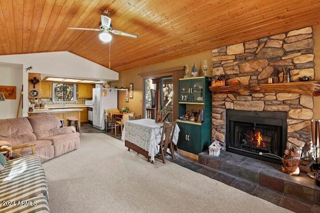 living room with dark colored carpet, ceiling fan, plenty of natural light, and wood ceiling