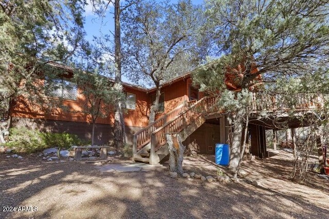 back of house featuring a wooden deck