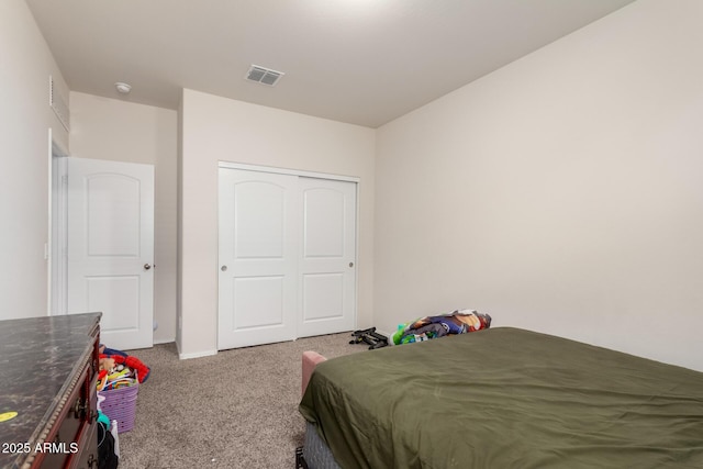 bedroom with a closet, carpet floors, visible vents, and baseboards