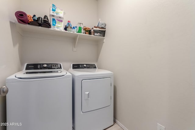 laundry area featuring baseboards, washing machine and clothes dryer, and laundry area